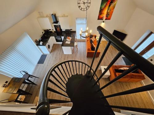 a view of a living room with a fan at Brooke View Barns No2 in Norwich