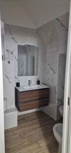 a bathroom with a sink and a mirror at Campanile 17 in Manfredonia