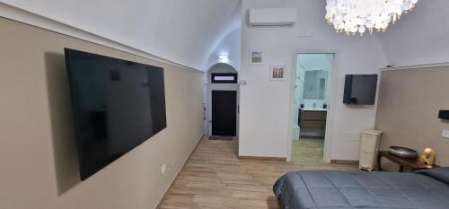 a bedroom with a large flat screen tv on the wall at Campanile 17 in Manfredonia