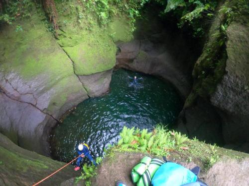a group of people rafting down a river in a cave at Valo's 360 Services in Portsmouth