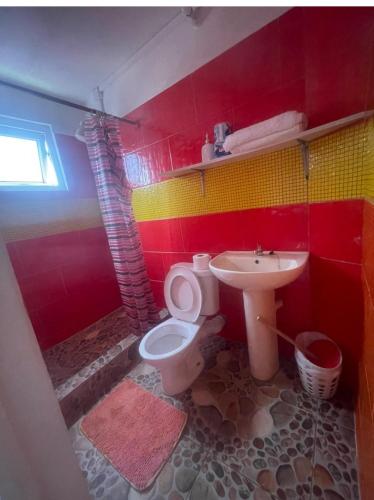a bathroom with a toilet and a sink at Valo's 360 Services in Portsmouth