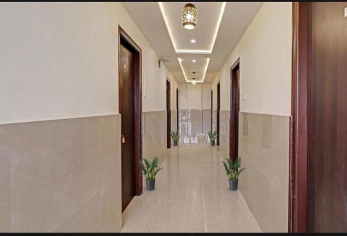 an empty hallway with potted plants in a building at SS Residency in Bengaluru