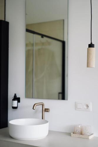 a bathroom with a white sink and a mirror at Toi-t et moi, Charming penthouse, view et nature in Malmedy