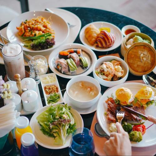 a table with many plates of food on it at Phuket V Building 19 Villas with Andaman Sea View Private Swimming Pool and Spa in Ban Ao Makham