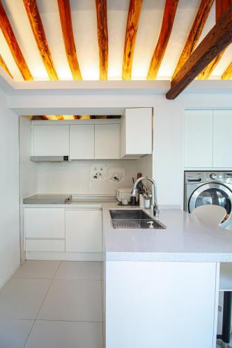 a kitchen with white cabinets and a sink at Cheongryang-Anchae 2BR 2BA Hanok Spa Free Parking in Seoul