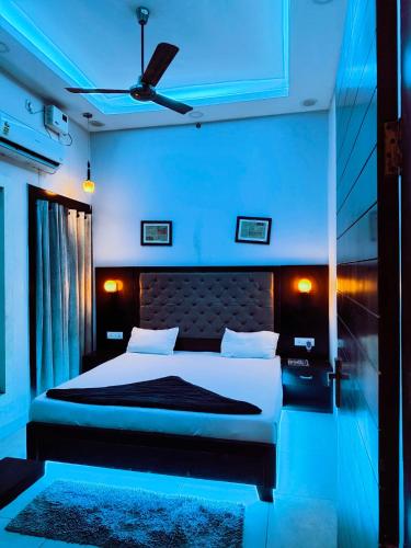 a bedroom with a bed with a blue light at The Miraj Hotel in Murthal