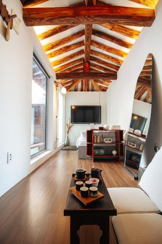 a living room with a couch and a table at Cheongryang-Anchae 2BR 2BA Hanok Spa Free Parking in Seoul