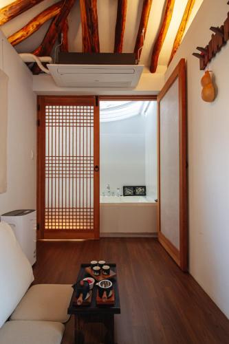 a living room with a couch and a table at Cheongryang-Anchae 2BR 2BA Hanok Spa Free Parking in Seoul