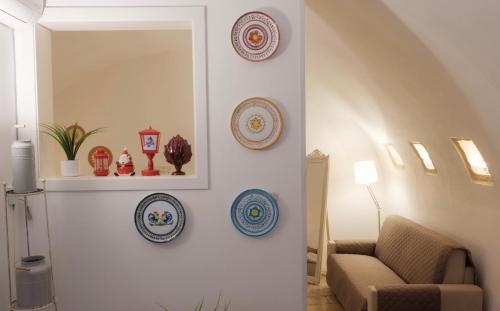 a living room with plates on a wall at Bari Vecchia Suite in Bari