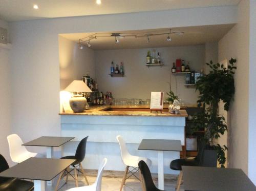 a restaurant with tables and chairs and a bar at Bristol Logis Cit'Hotel Périgueux Centre in Périgueux