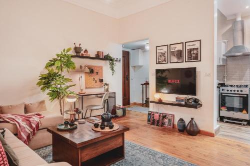 a living room with a couch and a tv at Retro Nutshell! in Cairo
