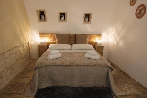 a bedroom with a large bed with towels on it at Bari Vecchia Suite in Bari