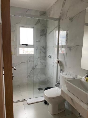 a bathroom with a shower and a toilet and a sink at 25 homeApart in Encarnación
