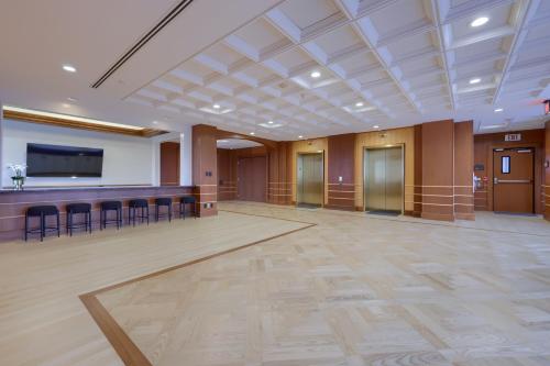 a large room with a bar and a flat screen tv at The Executive Suites and Events in Ephrata