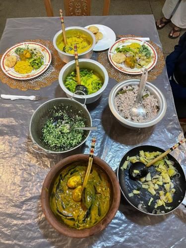 a table full of bowls of food on a table at Rose Palace in Nuwara Eliya