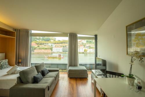 a living room with a couch and a large window at LUXURY VIEWS by YoursPorto in Vila Nova de Gaia