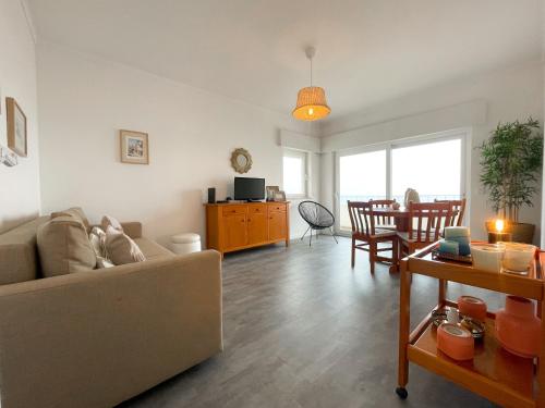a living room with a couch and a table at Apartamento T1, Praia da Rocha - Edificio Mar Azul in Portimão