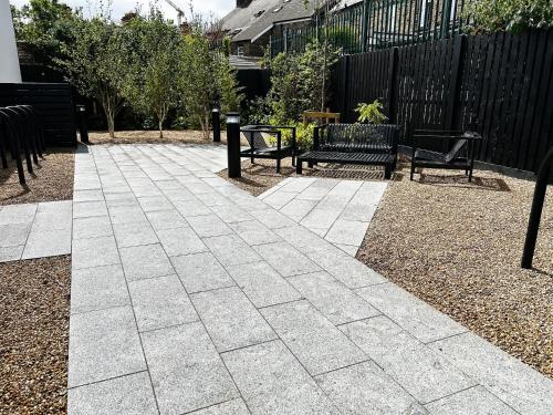 a patio with two benches and a table and chairs at The Residence Dublin in Dublin