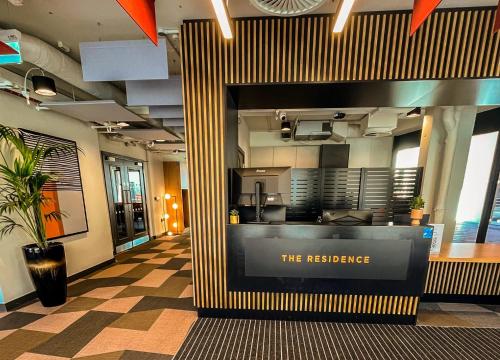 a restaurant with a counter in the middle of a building at The Residence Dublin in Dublin
