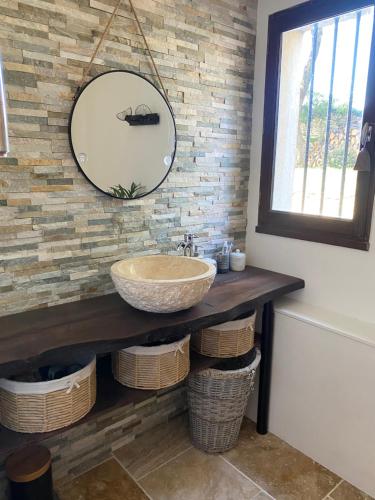 a bathroom with a sink and a mirror at Maison proche centre village in Grignan