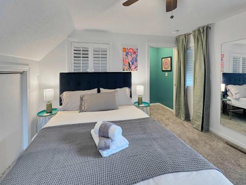 a bedroom with a large bed with a blue headboard at Coffee Lover's Paradise - Heart of Tremont in Cleveland
