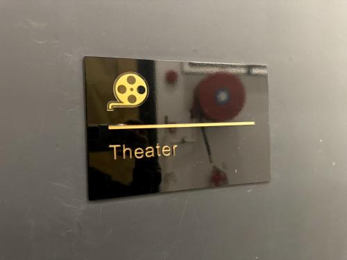 a metal box with a sign that says theater at Big screen cinema tv, 5 queen bed Luxury apt 2cp in Jelutong