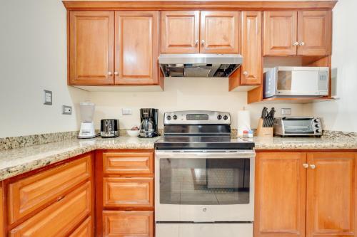 a kitchen with wooden cabinets and a stove top oven at Oceanica 804 in Playa Flamingo