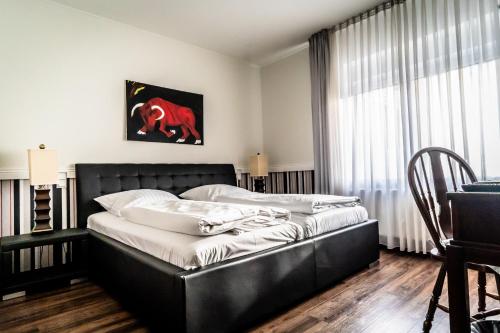 a bed in a room with a large window at Privathotel Stickdorn in Bad Oeynhausen