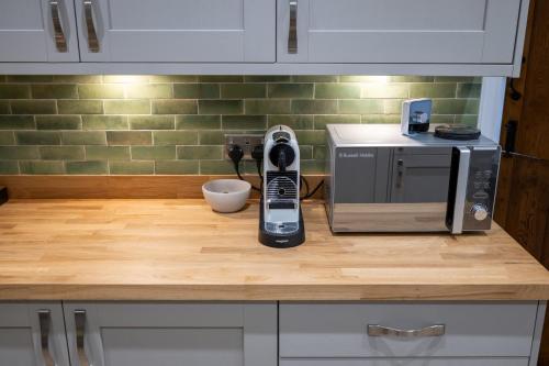a kitchen with a microwave and a phone on a counter at 2 Bed Ironbridge in Ironbridge
