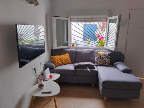 a living room with a couch and a table at La casita in Arafo