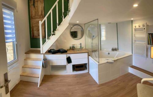 a bathroom with a shower and a sink and a tub at Maisonnette Individuelle in Carpiquet
