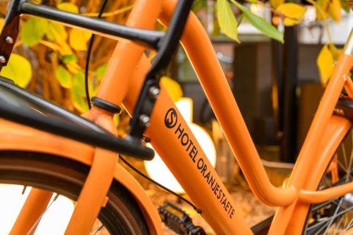 an orange bike with the word socialism written on it at Hotel Oranjestaete in Nijmegen