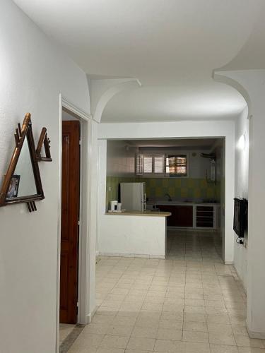 a kitchen with a white counter and a kitchen with a counter at Family-Friendly Studio in Mahdia