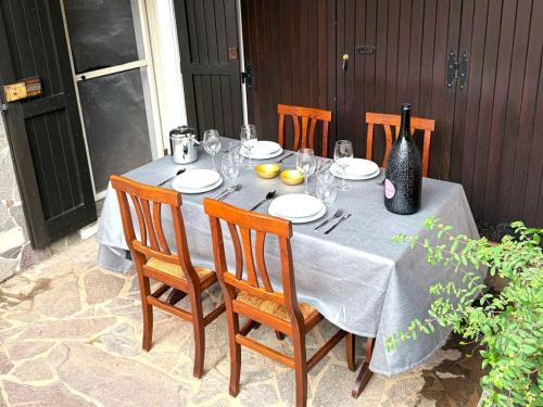 a table with chairs and a bottle of wine on it at dépendance President villa Tuerredda in Chia