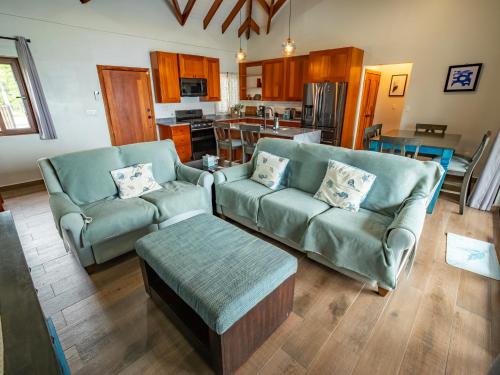 a living room with two couches and a table at Maya Beach Hotel in Maya Beach