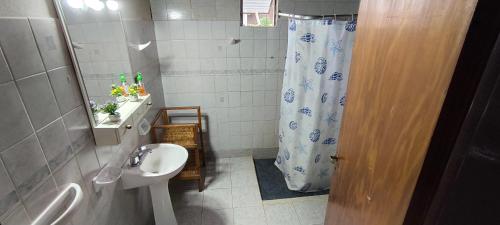 a bathroom with a sink and a shower curtain at Lo de Toty 1 in Yapeyú