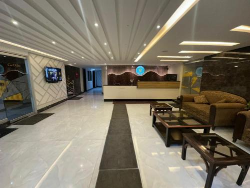 a living room with a couch and a table at Hotel Summer Palace Murree in Murree