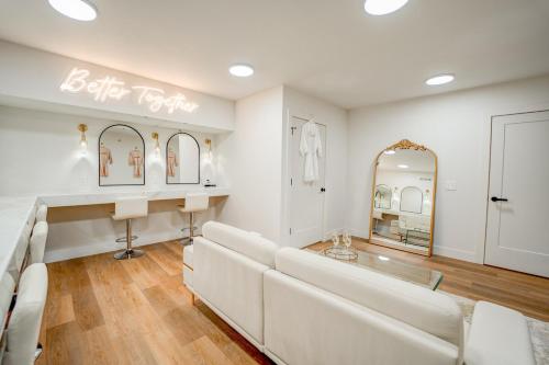 a white living room with a white couch and mirrors at Luxury getaway at The Winslow in Winslow