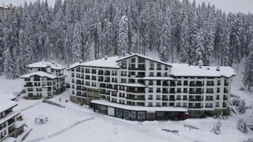 an aerial view of a hotel in the snow at Elit Pamporovo Accommodation in Pamporovo