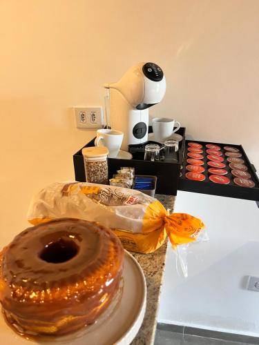 a table with two donuts on a counter with a plate at Recanto Góes Machado, quarto Gabi in São Roque