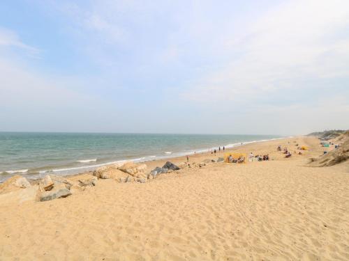 a group of people sitting on the beach at 19 Stablefield Way in Great Yarmouth