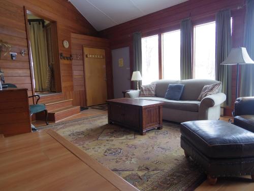 a living room with a couch and a table at Slopesider 23C condo in Sugar Mountain