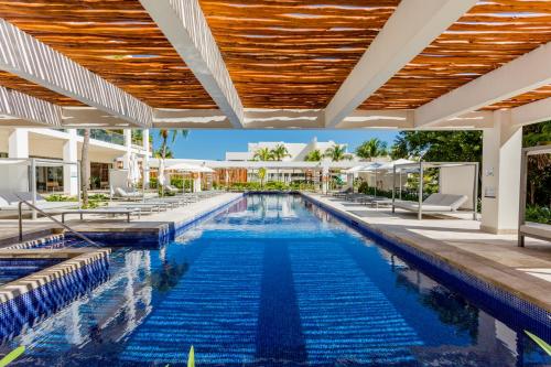 an image of a swimming pool at a resort at Luxury 2-Bedroom Apartment with Beach Club Access in Cancún