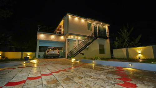 a house with a car parked in front of it at night at The Oakland INN in Yercaud