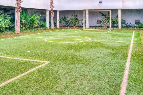 a tennis court in front of a building at BlueVista - Yacht like Escape with Ocean Views in Rabat