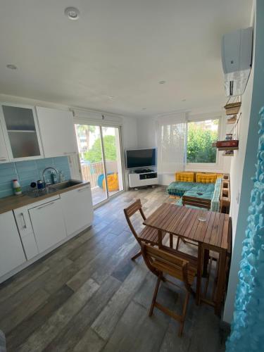 une cuisine et un salon avec une table et un canapé dans l'établissement Appt Fréjus 4 personnes plage à 100m, à Fréjus