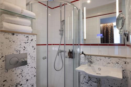 a bathroom with a shower and a sink at Hotel Locomo - Gare de Lyon Bastille in Paris