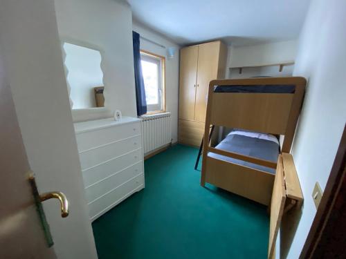a small room with a bunk bed and a window at Mountain View in Passo del Tonale