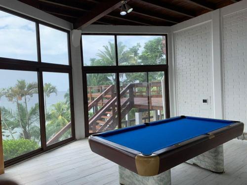 a pool table in a room with large windows at Casa Carabela, Omoa, Cortes in Omoa