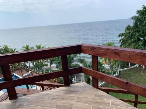 a wooden boardwalk leading to a beach with the ocean at Casa Carabela, Omoa, Cortes in Omoa